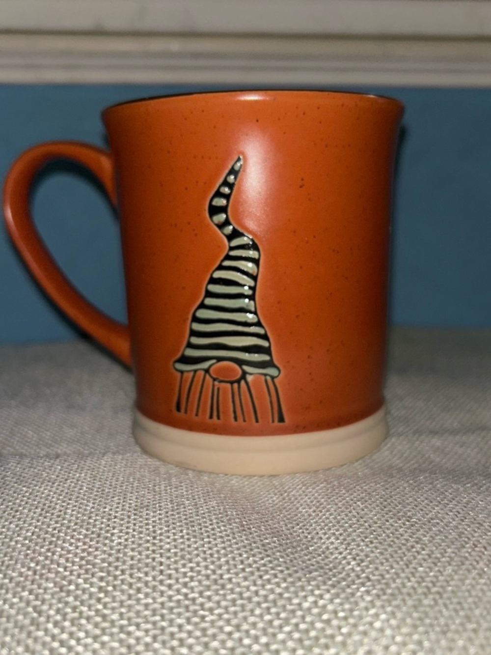 Orange Ceramic Mug with Cream Base and Striped Gnome Accent